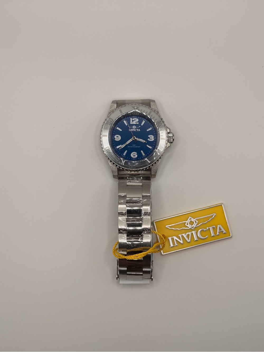 Invicta Men’s Silver Stainless Steel Watch with Blue Dial and Yellow Tag